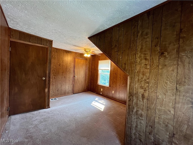 1365 Craneing Rd, Wickliffe, OH 44092 - bonus room with wood walls, a textured ceiling, carpet floors, and a ceiling fan