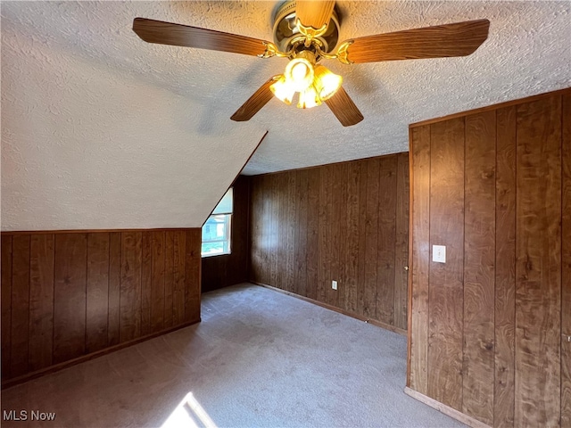 1365 Craneing Rd, Wickliffe, OH 44092 - bonus room with a textured ceiling, wooden walls, a ceiling fan, and carpet floors