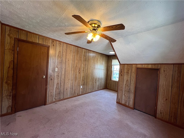 1365 Craneing Rd, Wickliffe, OH 44092 - bonus room featuring a textured ceiling, wooden walls, ceiling fan, and carpet floors