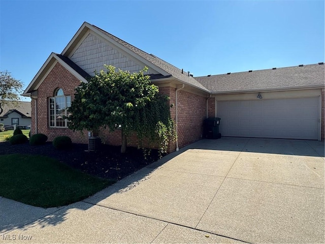 1204 Saint Abigail St SW, Hartville, OH 44632 - view of front of property with brick siding, driveway, and an attached garage