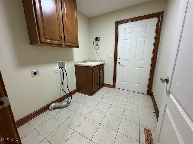 1204 Saint Abigail St SW, Hartville, OH 44632 - laundry area featuring hookup for an electric dryer, cabinet space, washer hookup, and light tile patterned floors