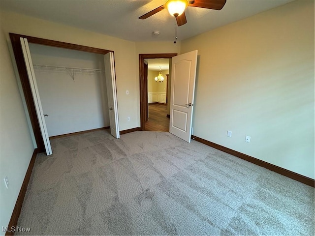 1204 Saint Abigail St SW, Hartville, OH 44632 - unfurnished bedroom featuring light carpet, a closet, a chandelier, and a ceiling fan
