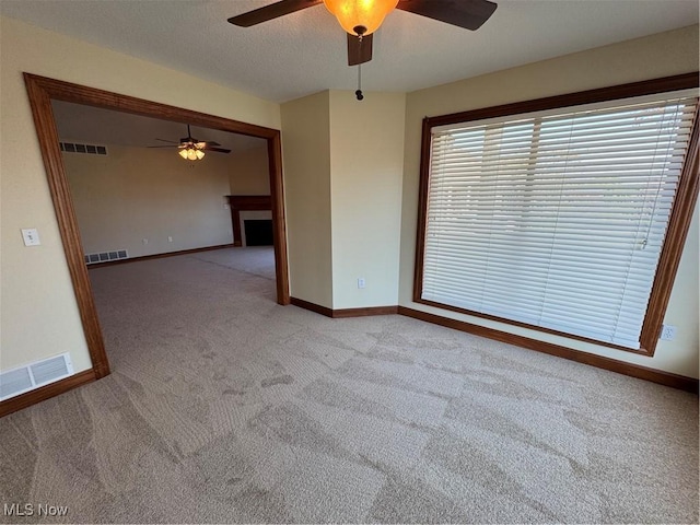 1204 Saint Abigail St SW, Hartville, OH 44632 - carpeted spare room with a ceiling fan and a fireplace