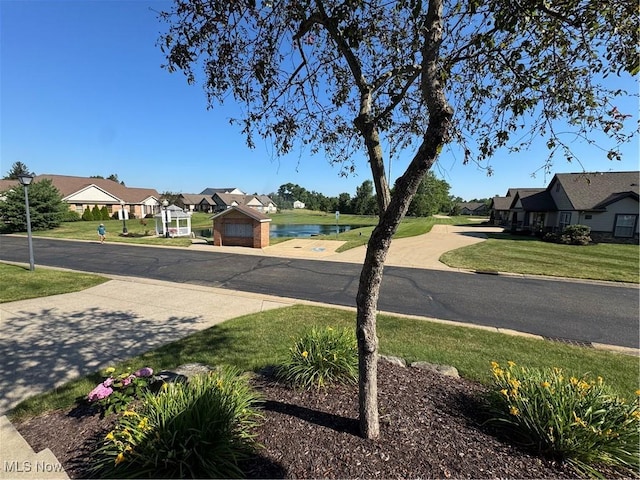 1204 Saint Abigail St SW, Hartville, OH 44632 - view of asphalt road with a water view, street lights, and a residential view