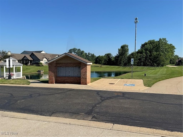 1204 Saint Abigail St SW, Hartville, OH 44632 - view of front of home with a gazebo, a water view, brick siding, and a front yard