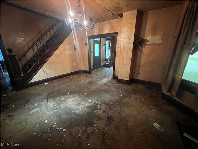 1529 Stark Ave SW, Canton, OH 44706 - unfurnished living room with unfinished concrete floors and stairway