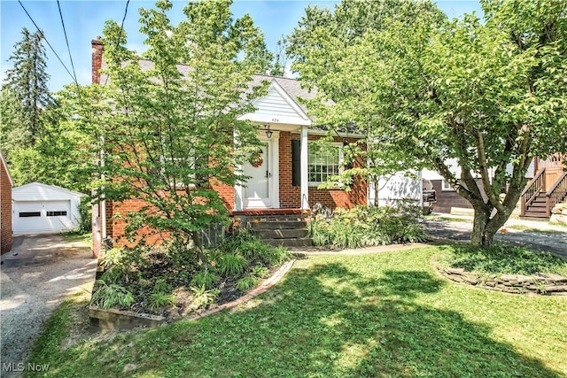 474 W 4th St, Salem, OH 44460 - view of property hidden behind natural elements with brick siding, an outbuilding, a detached garage, a chimney, and a front yard