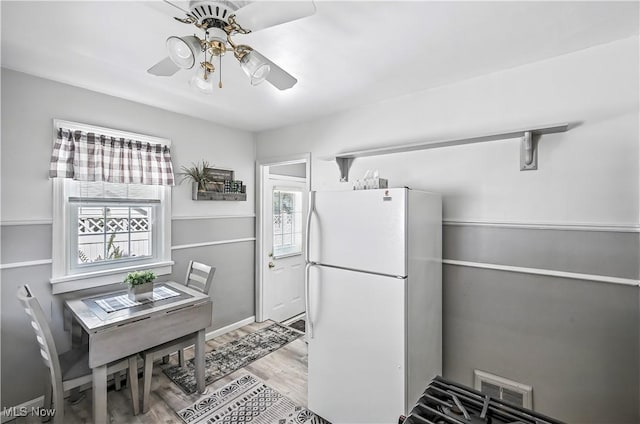 474 W 4th St, Salem, OH 44460 - kitchen with freestanding refrigerator, ceiling fan, light wood-style floors, and plenty of natural light