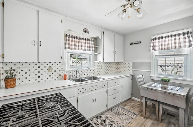 474 W 4th St, Salem, OH 44460 - kitchen featuring light countertops, backsplash, light wood finished floors, and white cabinets