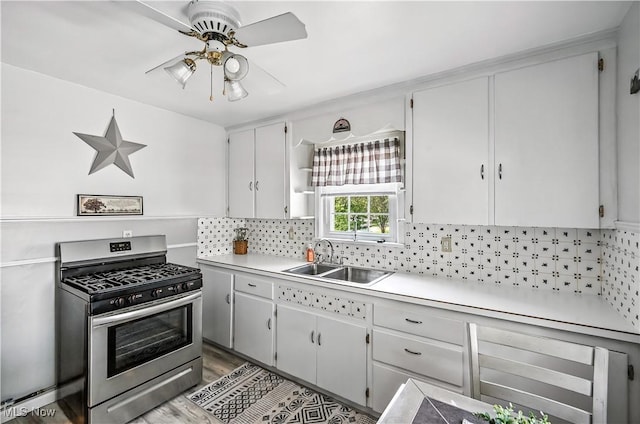 474 W 4th St, Salem, OH 44460 - kitchen featuring stainless steel range with gas cooktop, ceiling fan, tasteful backsplash, light countertops, and white cabinetry