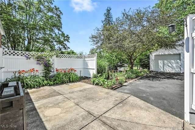 474 W 4th St, Salem, OH 44460 - view of patio with a garage and driveway
