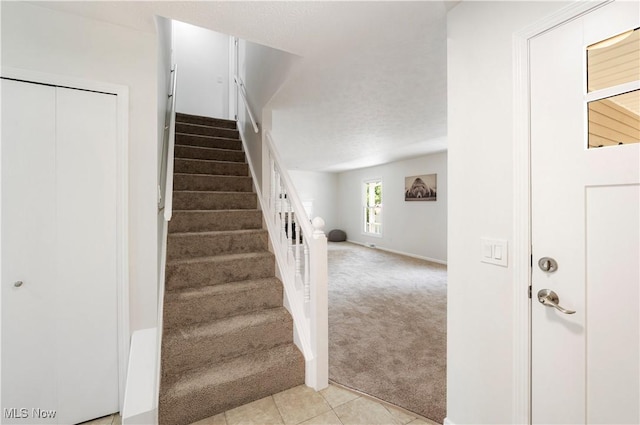 12366 Springwater Ave NW, Uniontown, OH 44685 - stairway with carpet flooring and tile patterned flooring
