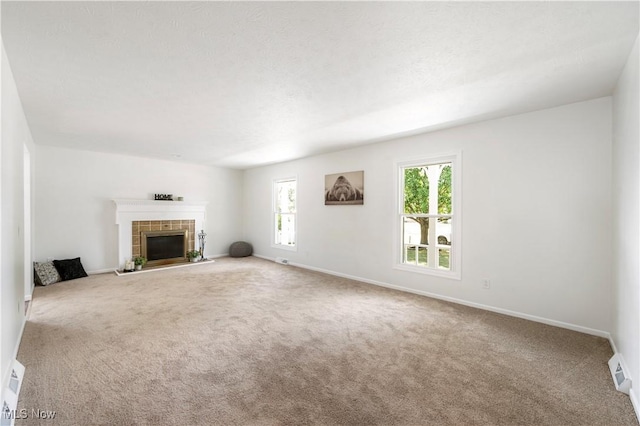 12366 Springwater Ave NW, Uniontown, OH 44685 - unfurnished living room with carpet flooring and a tiled fireplace
