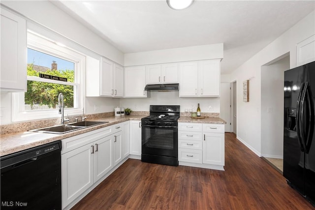 12366 Springwater Ave NW, Uniontown, OH 44685 - kitchen with black appliances, under cabinet range hood, light countertops, dark wood-style flooring, and white cabinets