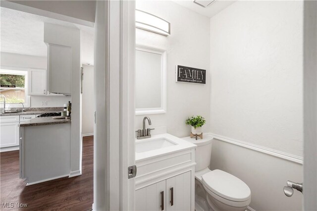 12366 Springwater Ave NW, Uniontown, OH 44685 - half bathroom with vanity and wood finished floors