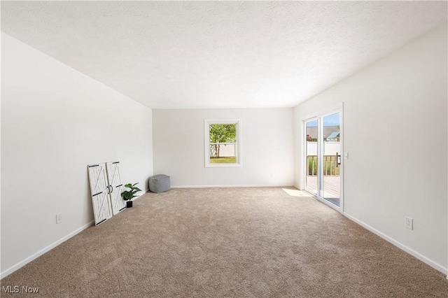 12366 Springwater Ave NW, Uniontown, OH 44685 - carpeted empty room with baseboards and a textured ceiling