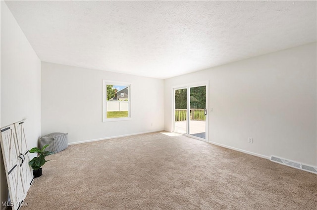 12366 Springwater Ave NW, Uniontown, OH 44685 - spare room featuring carpet and a textured ceiling