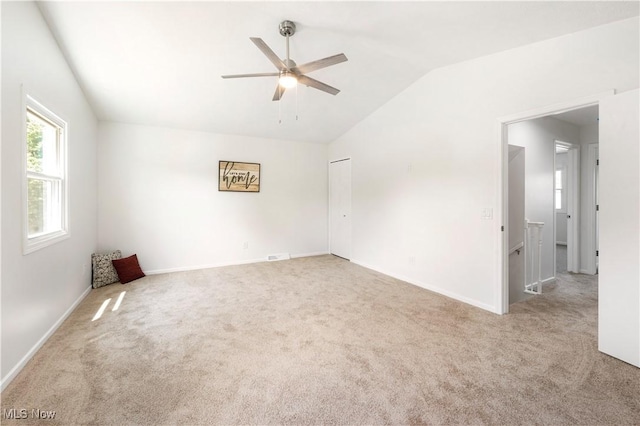 12366 Springwater Ave NW, Uniontown, OH 44685 - carpeted spare room with vaulted ceiling and ceiling fan