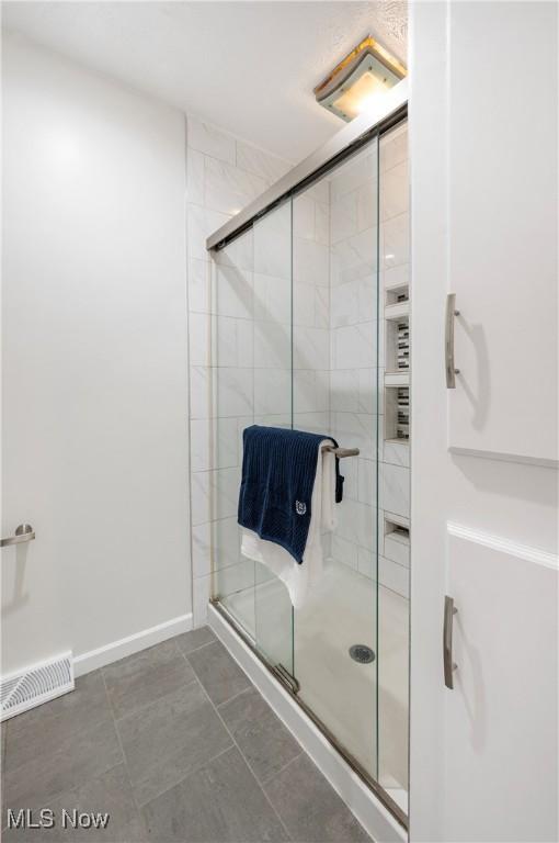 12366 Springwater Ave NW, Uniontown, OH 44685 - full bathroom with a stall shower and baseboards