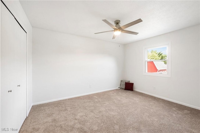 12366 Springwater Ave NW, Uniontown, OH 44685 - unfurnished bedroom with carpet flooring, a closet, and ceiling fan