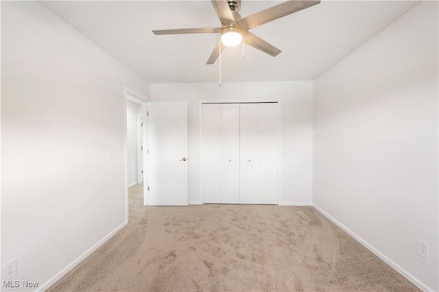 12366 Springwater Ave NW, Uniontown, OH 44685 - unfurnished bedroom featuring carpet floors, a closet, and a ceiling fan
