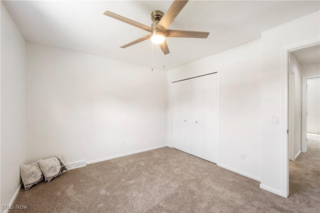 12366 Springwater Ave NW, Uniontown, OH 44685 - unfurnished bedroom featuring carpet floors, a closet, and ceiling fan