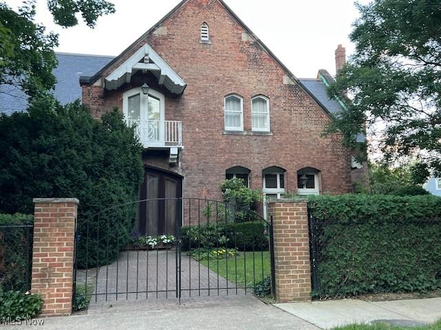 27 Garfield Ln, Bratenahl, OH 44108 - english style home featuring brick siding, a gate, and french doors