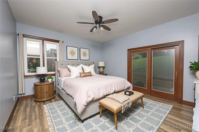 1096 Colegate Dr, Marietta, OH 45750 - bedroom with wood finished floors, access to exterior, and ceiling fan