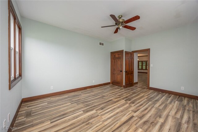 1096 Colegate Dr, Marietta, OH 45750 - empty room featuring wood finished floors, ceiling fan, and plenty of natural light
