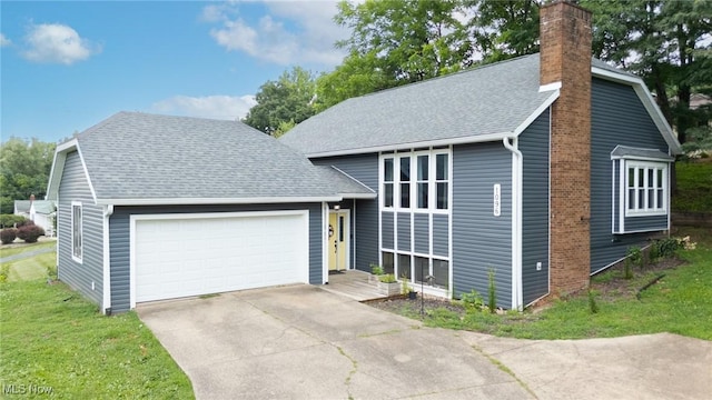 1096 Colegate Dr, Marietta, OH 45750 - tri-level home with a garage, a chimney, concrete driveway, and a shingled roof
