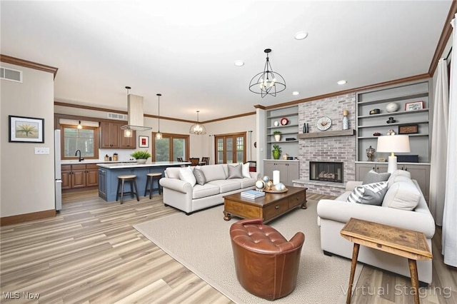 1096 Colegate Dr, Marietta, OH 45750 - living room featuring light wood finished floors, recessed lighting, crown molding, a fireplace, and built in features