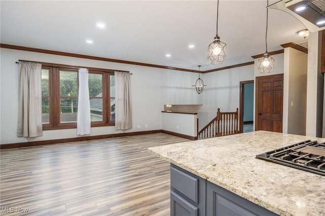 1096 Colegate Dr, Marietta, OH 45750 - kitchen with light wood finished floors, ornamental molding, gray cabinets, decorative light fixtures, and light stone counters