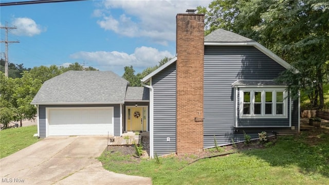 1096 Colegate Dr, Marietta, OH 45750 - view of front of house with a chimney, a garage, a front lawn, and driveway