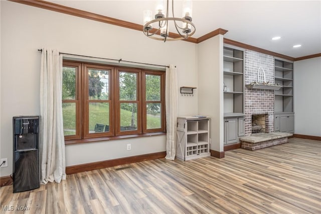 1096 Colegate Dr, Marietta, OH 45750 - unfurnished living room with ornamental molding, a chandelier, light wood-style floors, recessed lighting, and a brick fireplace