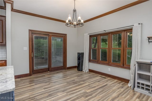 1096 Colegate Dr, Marietta, OH 45750 - unfurnished dining area featuring plenty of natural light, a chandelier, light wood-style floors, and ornamental molding