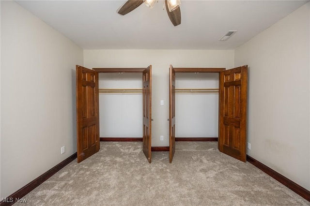 1096 Colegate Dr, Marietta, OH 45750 - unfurnished bedroom with carpet, a ceiling fan, and two closets