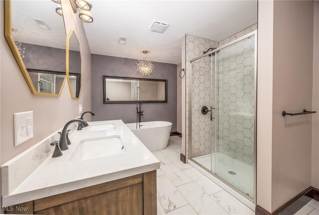 1096 Colegate Dr, Marietta, OH 45750 - full bathroom with marble finish flooring, a shower stall, double vanity, and a freestanding tub