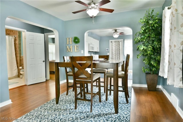 364 Meadowbrook Ave SE, Warren, OH 44483 - dining space with ceiling fan, wood finished floors, and arched walkways
