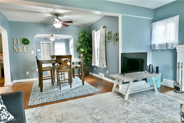 364 Meadowbrook Ave SE, Warren, OH 44483 - dining room featuring arched walkways, ceiling fan, and wood finished floors