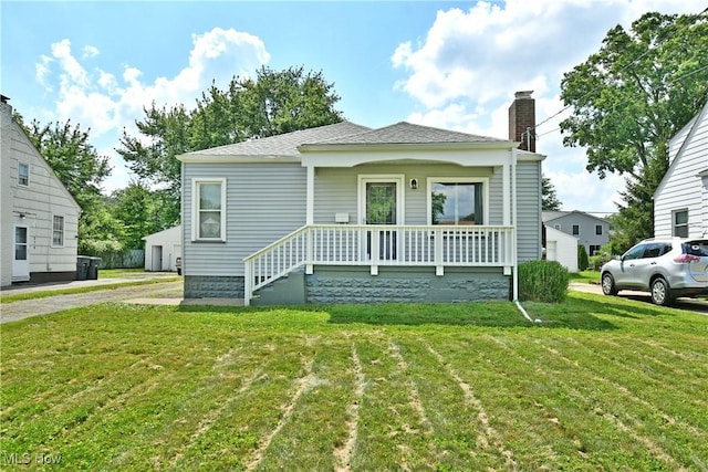 364 Meadowbrook Ave SE, Warren, OH 44483 - bungalow-style house with a chimney, covered porch, a front yard, and a shingled roof