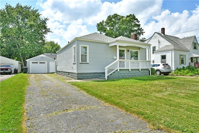 364 Meadowbrook Ave SE, Warren, OH 44483 - view of front facade featuring a chimney, a front lawn, an outbuilding, a garage, and a porch