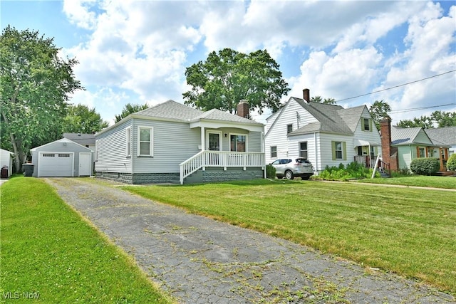 364 Meadowbrook Ave SE, Warren, OH 44483 - bungalow-style home featuring a garage, an outbuilding, a front lawn, driveway, and a chimney