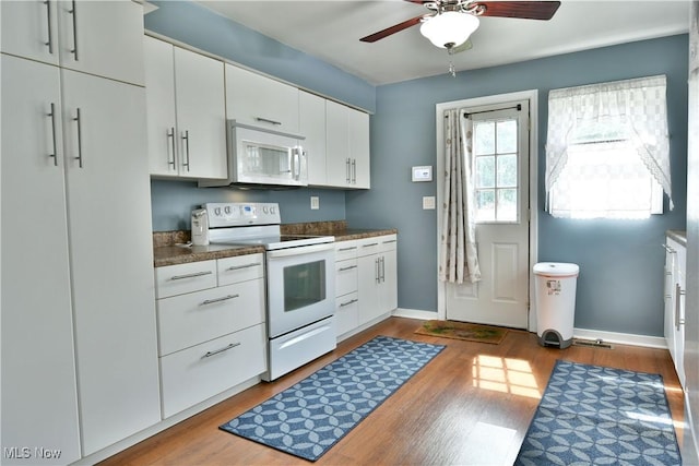 364 Meadowbrook Ave SE, Warren, OH 44483 - kitchen featuring white appliances, a ceiling fan, dark wood-style flooring, white cabinets, and dark countertops