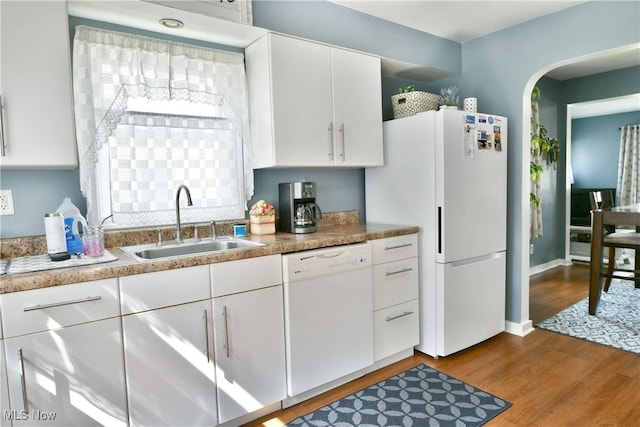 364 Meadowbrook Ave SE, Warren, OH 44483 - kitchen with white appliances, wood finished floors, white cabinetry, arched walkways, and light countertops