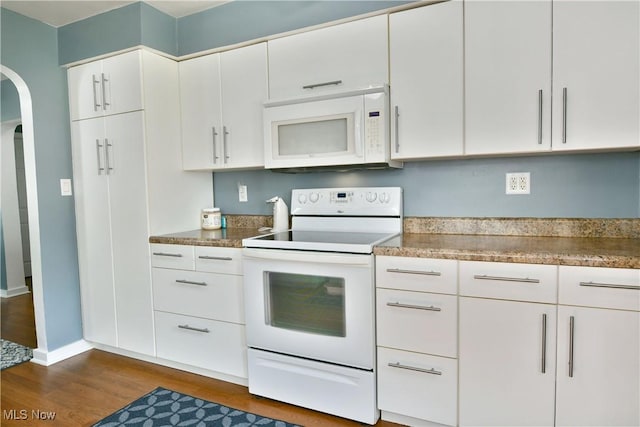 364 Meadowbrook Ave SE, Warren, OH 44483 - kitchen with white appliances, arched walkways, dark wood-type flooring, and white cabinets