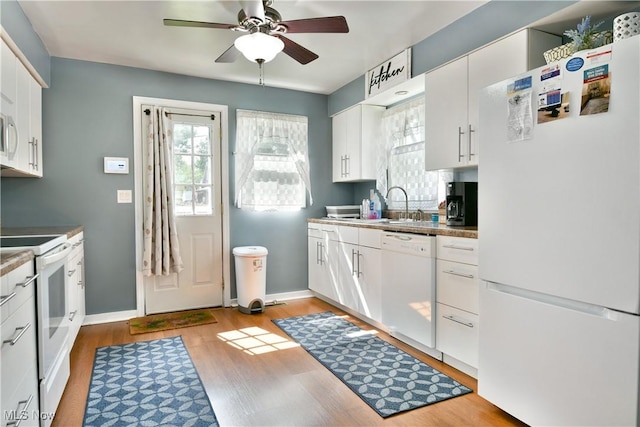 364 Meadowbrook Ave SE, Warren, OH 44483 - kitchen with white appliances, a ceiling fan, light wood-type flooring, and white cabinets