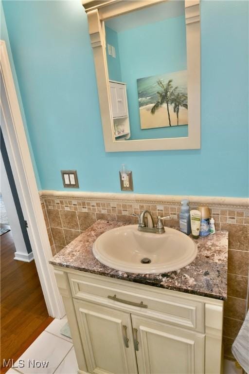 364 Meadowbrook Ave SE, Warren, OH 44483 - bathroom featuring tile walls, vanity, and a wainscoted wall