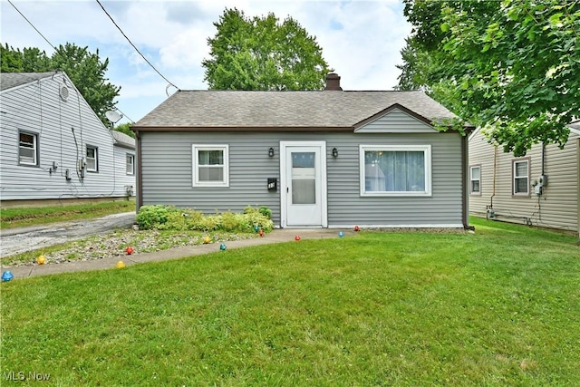 33 Mcdonald Ave, Niles, OH 44446 - bungalow featuring a front lawn, roof with shingles, and a chimney