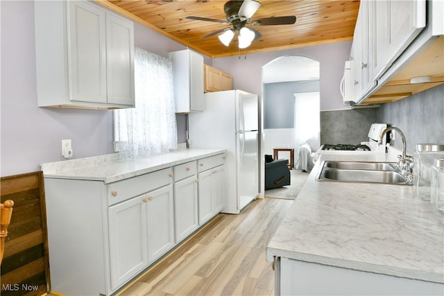 33 Mcdonald Ave, Niles, OH 44446 - kitchen with wooden ceiling, ceiling fan, arched walkways, white appliances, and light wood finished floors