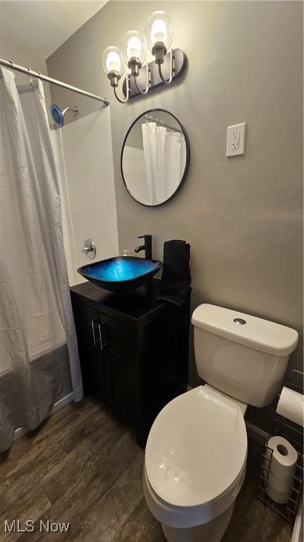 25801 Zeman Ave, Euclid, OH 44132 - full bathroom with wood finished floors, vanity, a chandelier, and shower / bath combo